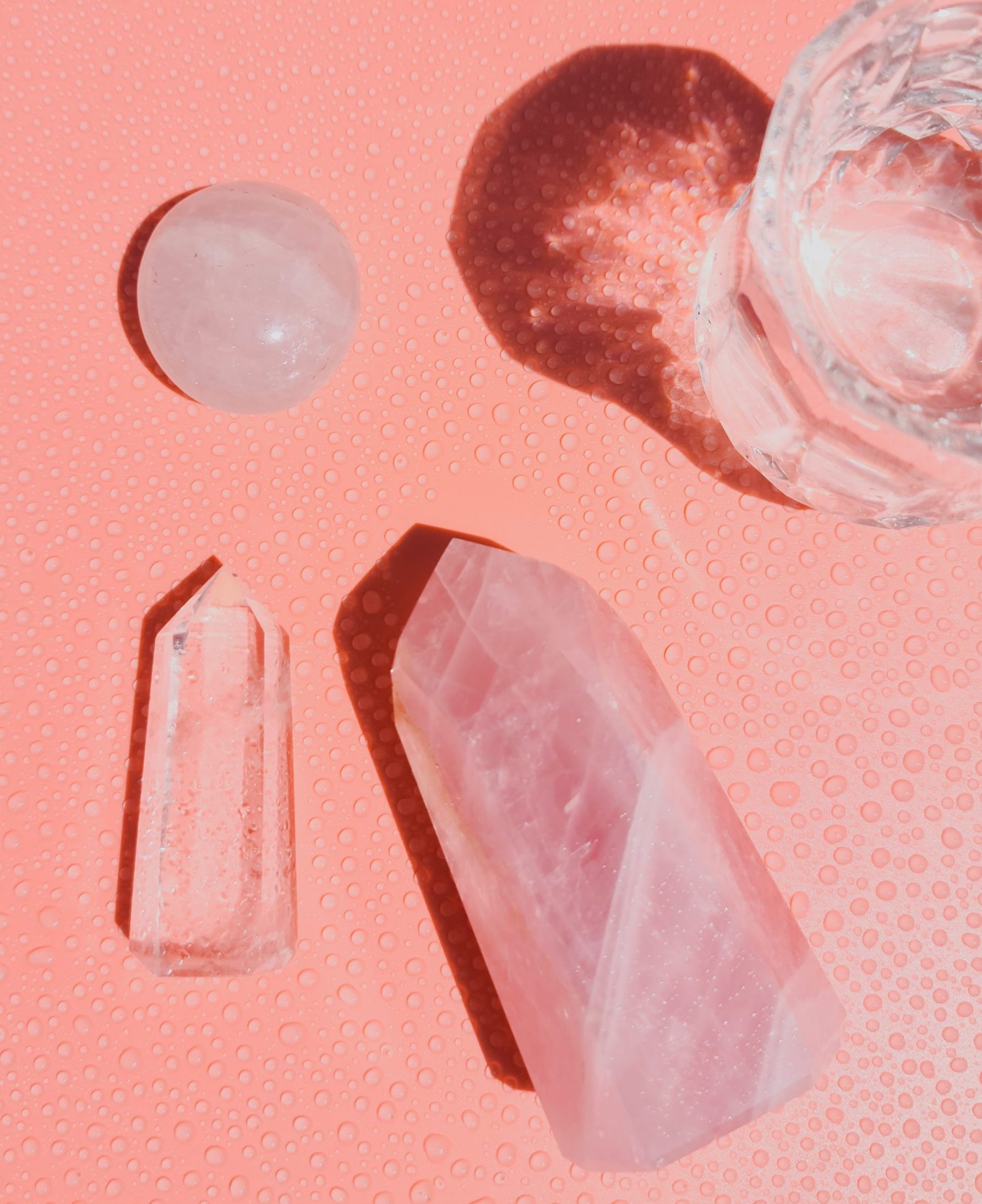 clear quartz crystal on pink background