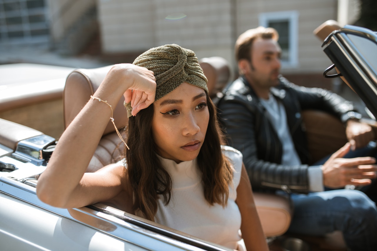 man and woman not talking sitting in convertible